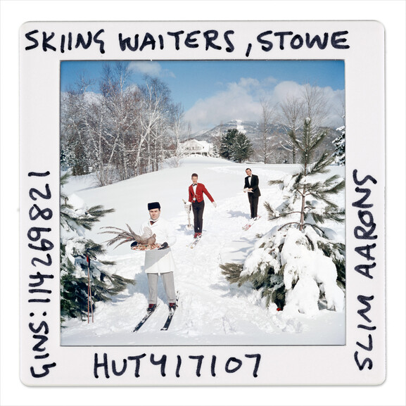 Skiing Waiters Slide - by Slim Aarons