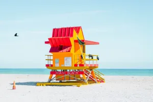 Colorful Miami Beach lifeguard tower with blue sky.