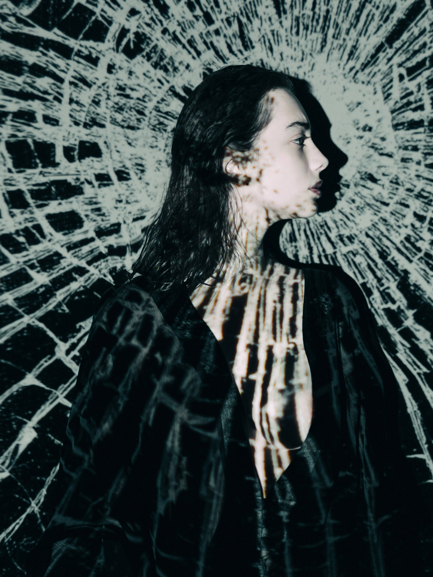 Young woman standing against projection screen
