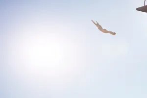 Woman diving from platform