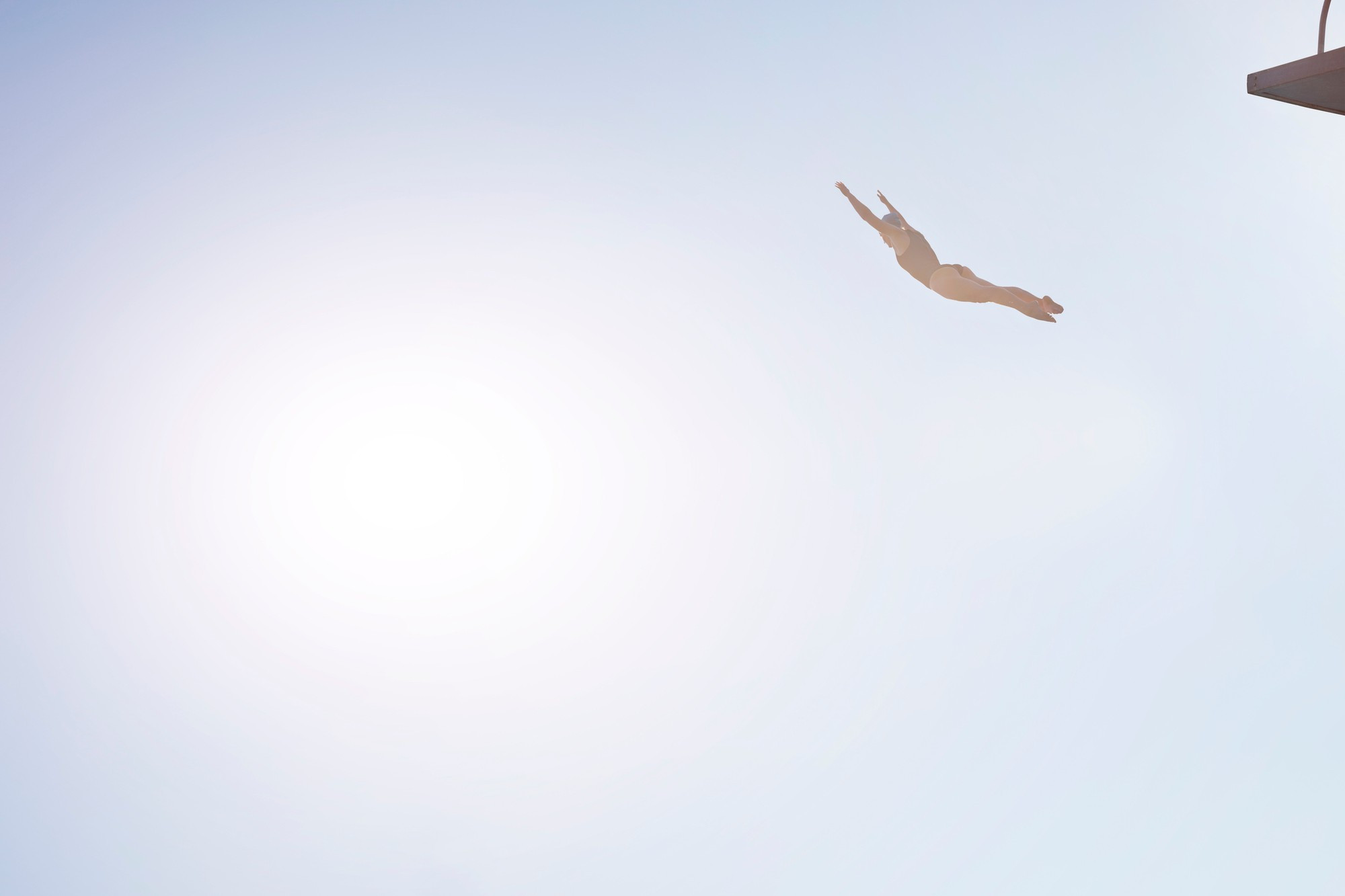 Woman diving from platform