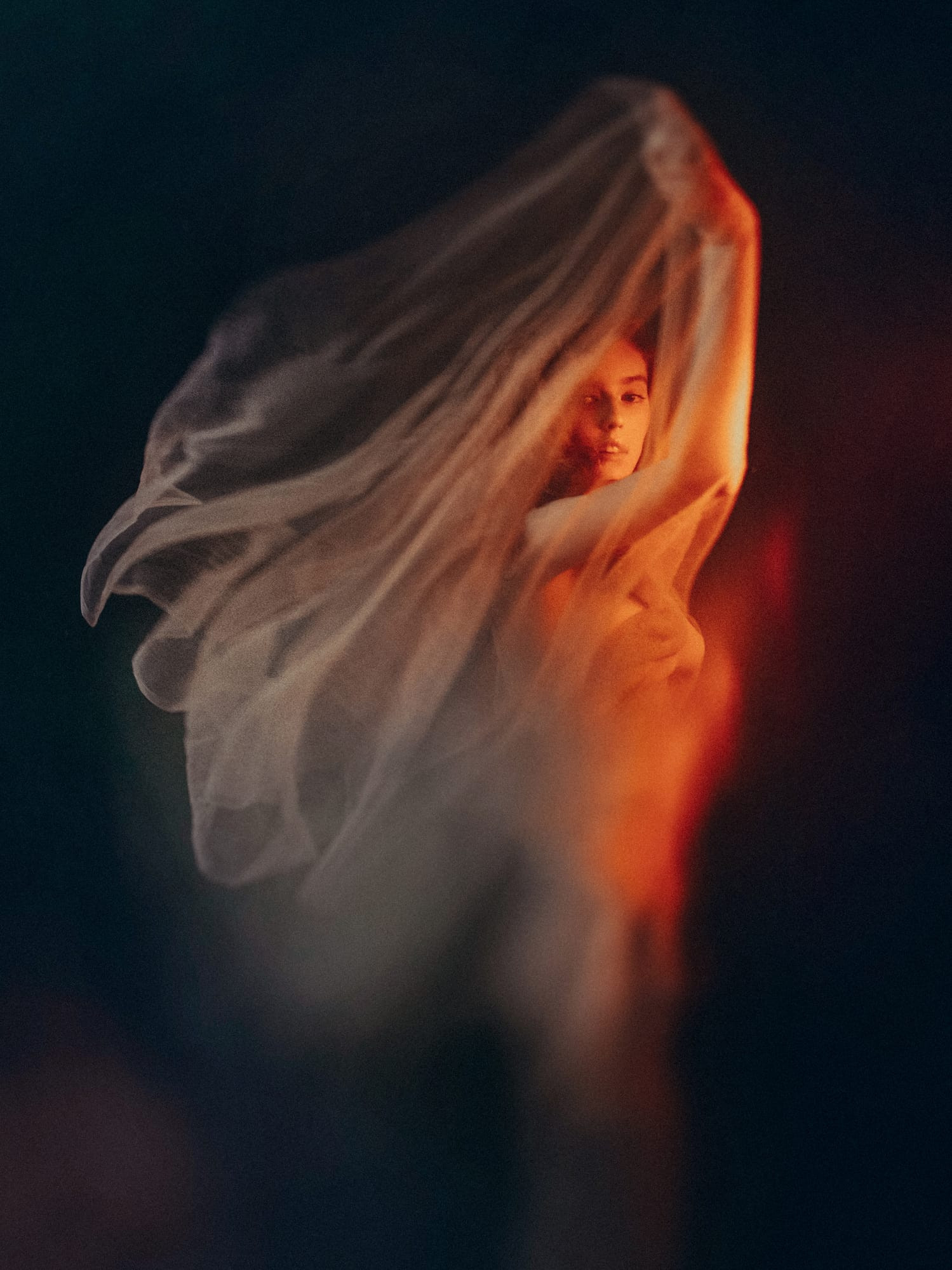 Serious redhead woman covered with white silk