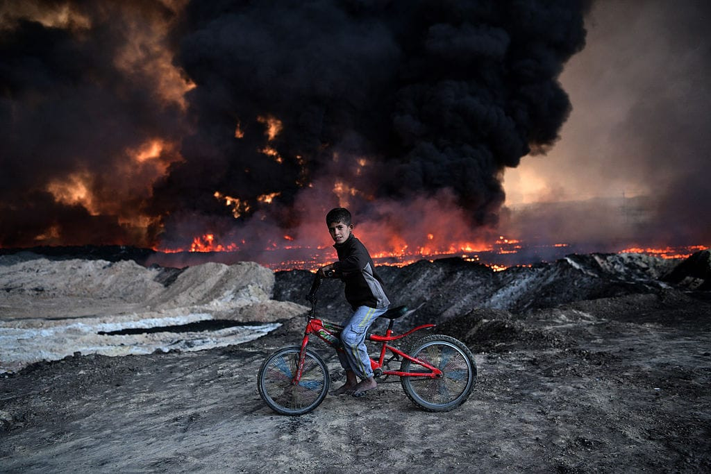 Boy and Burning Oil Field